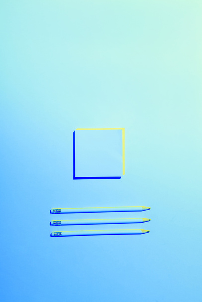 blue toned picture of sticky note and three pencils placed in row  - Φωτογραφία, εικόνα