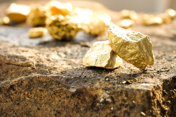 The pure gold ore found in the mine on a stone floor - Photo, Image