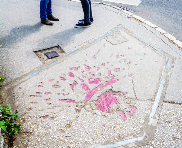 Markings on streets of Sarajevo indicating mortar shells exploded during Bosnian war in 1990s - Photo, Image