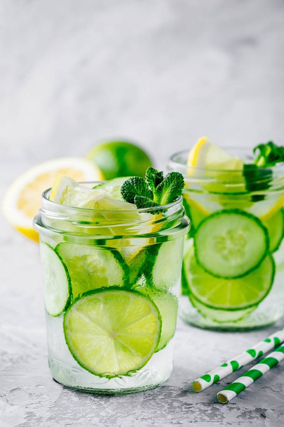 Infused detox water with cucumber, lemon and lime.  - Fotoğraf, Görsel