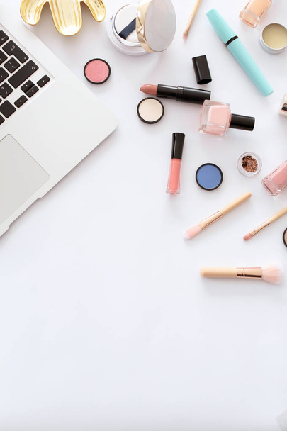 Flat lay composition with makeup products for woman and laptop on white background - Valokuva, kuva