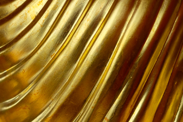 Abstract gold background, glossy metal that is a luxurious fabric is wave. - Photo, Image
