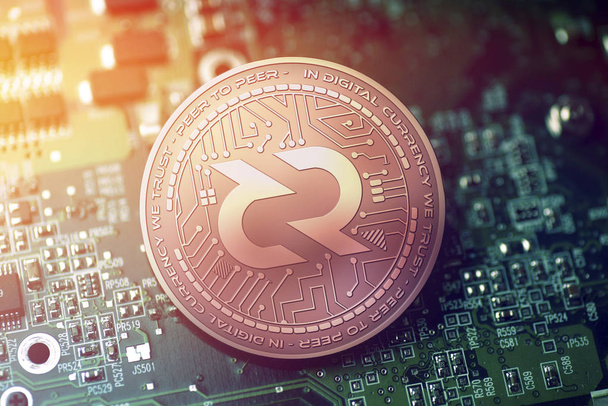 shiny copper DECRED cryptocurrency coin on blurry motherboard background - Photo, Image