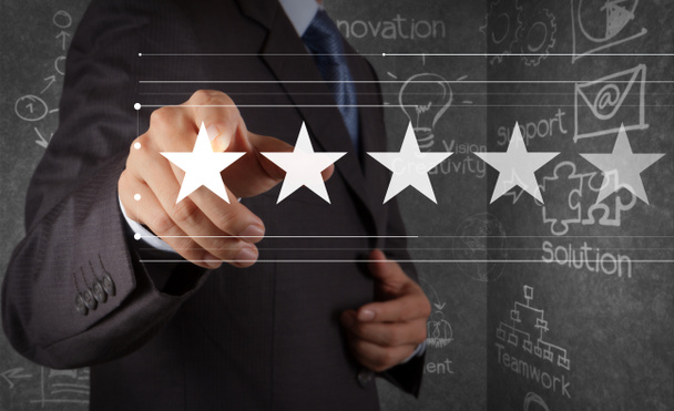 Five stars (5) rating with a businessman is touching virtual computer screen.For positive customer feedback and review with excellent performance. - Photo, Image