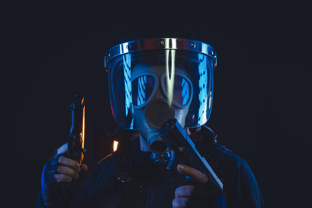 Special unit policeman in a gas mask and shield, isolated on black - Fotoğraf, Görsel