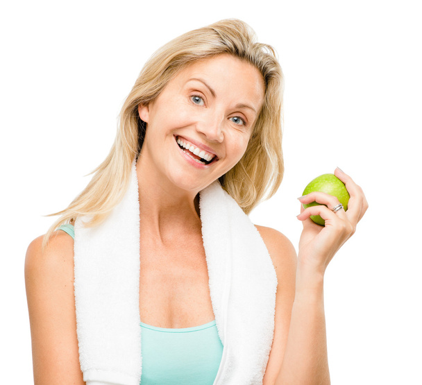 Healthy mature woman exercise green apple isolated on white background - Foto, Imagen