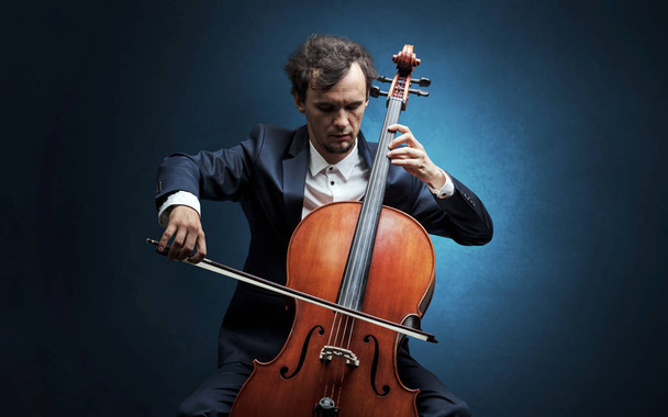 Cellist playing on instrument with empathy - Foto, imagen