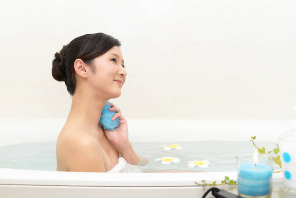 Young beautiful woman taking relaxing bath - Photo, Image