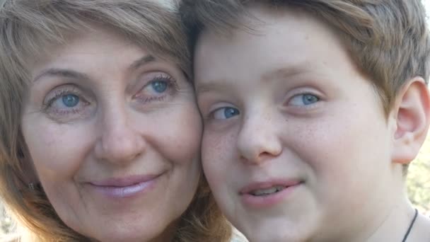 Portrait of adult middle-aged mother and her teen son - Footage, Video