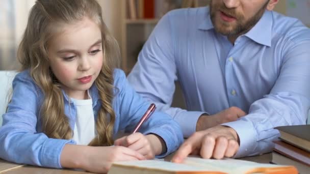 School girl doing homework with teacher, additional education, child development - Πλάνα, βίντεο