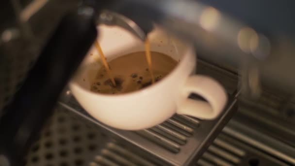 Coffee pouring into cup from coffee machine in restaurant close up - Felvétel, videó