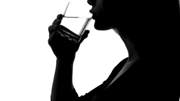 Woman shadow drinking water from glass, aqua balance, body hydrating, health - Filmmaterial, Video