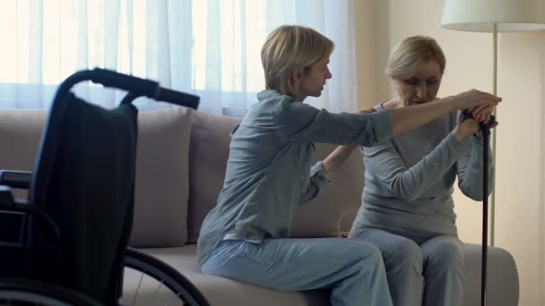 Female psychologist supporting lonely disabled senior woman at nursing home - Felvétel, videó