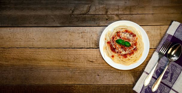 Spaghetti Pasta with Tomato Sauce, Cheese and Basil on Wooden Table. Traditional Italian Food. - Photo, Image