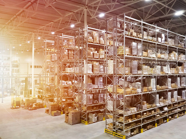 Large modern blurred warehouse industrial and logistics companies. Warehousing on the floor and called the high shelves - Photo, Image
