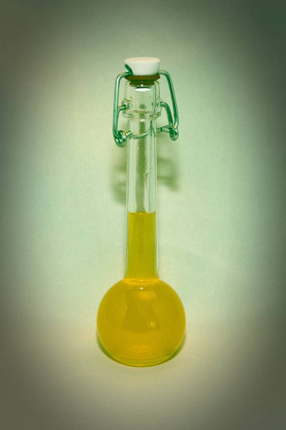Glass jar with bright liquid - Фото, зображення
