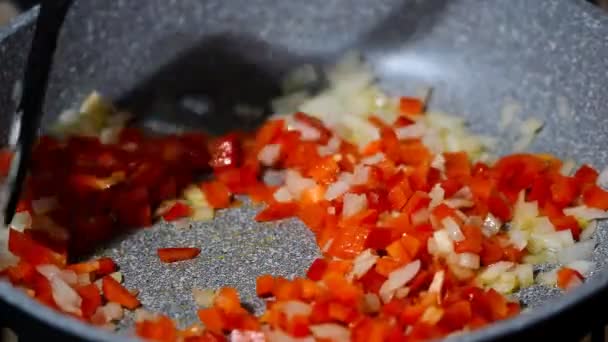 Τηγάνι με ψιλοκομμένο κρεμμύδι και πιπεριά σε ζεστό πιάτο - Πλάνα, βίντεο