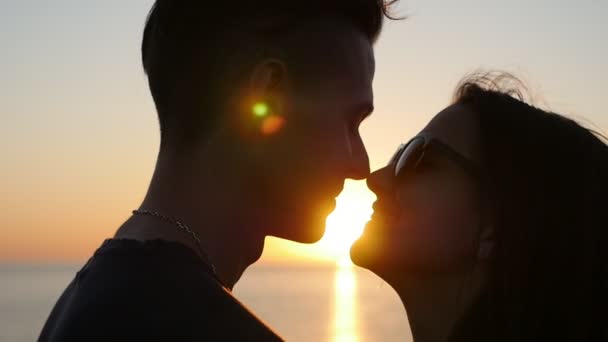 Eskimo kiss romantyczny dziewczyny i jej szczęśliwym chłopcem, nad Morzem Czarnym o zachodzie słońca, dobre sniadanie zakochany pary wzajemnie przytulanie i robi Eskimo kiss malowniczy zachód słońca na wybrzeżu Morza Czarnego w lecie - Materiał filmowy, wideo