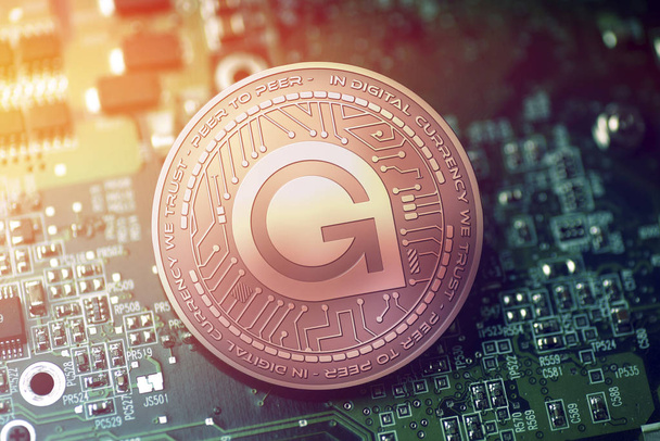 shiny copper GAMECREDITS cryptocurrency coin on blurry motherboard background - Photo, Image