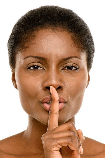 Cute African American woman finger on lips isolated on white bac - Фото, изображение
