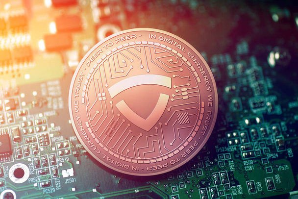 shiny copper GLADIUS cryptocurrency coin on blurry motherboard background - Photo, Image