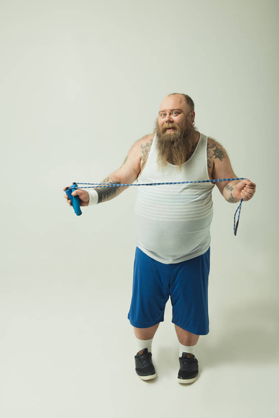 Joyful thick guy is ready to do sport - Фото, изображение
