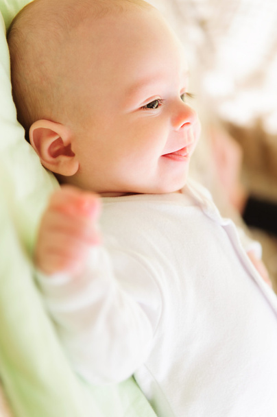Cute newborn baby smiling in bed - Fotoğraf, Görsel