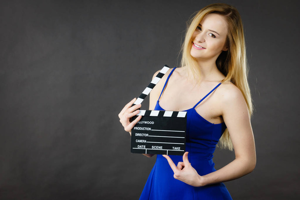 Woman holding professional film slate - Φωτογραφία, εικόνα