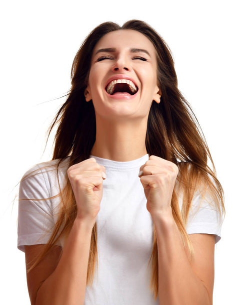 Brunette woman doing a winner gesture happy laughing excited looking up with closed eyes  - Φωτογραφία, εικόνα