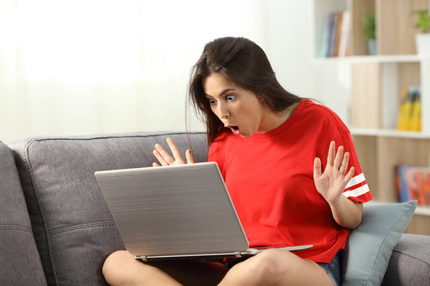 Amazed teen finding offers online at home - Fotó, kép