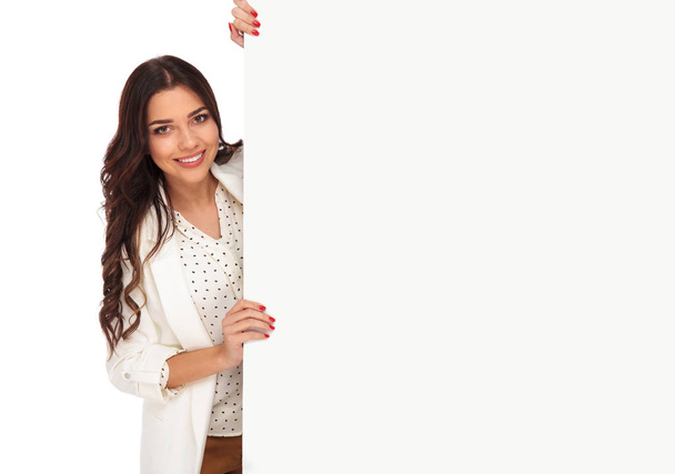 portrait of young businesswoman holding empty board from side - Photo, Image