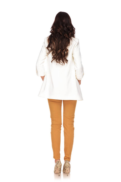 back view of businesswoman with hands in pockets standing - Photo, Image