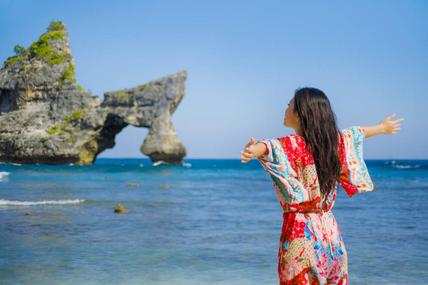 young happy and pretty tourist Asian Korean woman in Summer dress enjoying tropical paradise beach holidays posing arms opened free - Фото, зображення