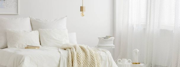 Simple lamp above bed - Фото, изображение