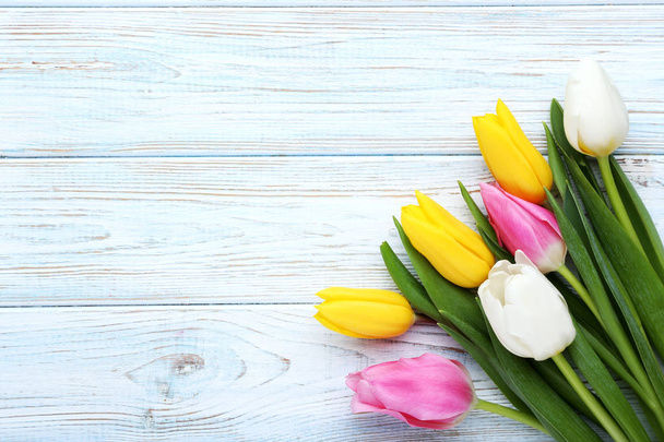 Bouquet of tulips on wooden table - Zdjęcie, obraz