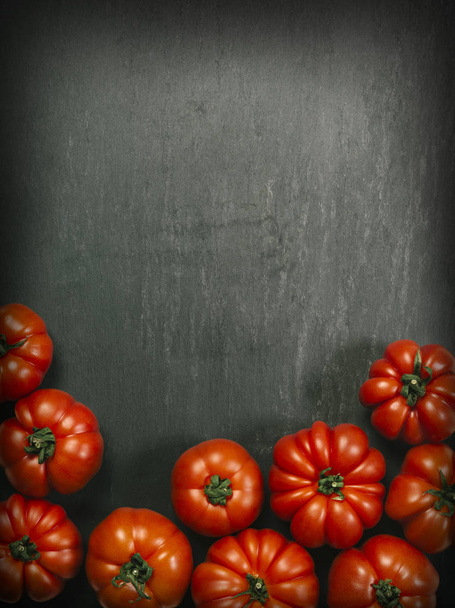Marmande tomatoes on slate background - Valokuva, kuva