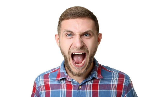 Portrait of young man screaming on white background - Fotografie, Obrázek