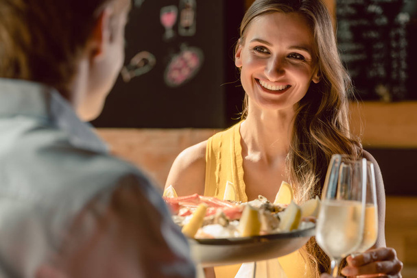 Heureux jeune couple amoureux de griller au champagne lors d'un dîner romantique avec des fruits de mer comme huîtres et crabes au restaurant
 - Photo, image