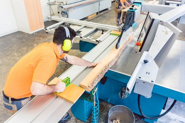 Tabla de cortar carpintero con sierra de mesa en su taller
 - Foto, Imagen