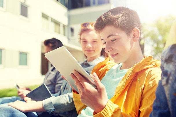 happy friends or students with tablet pc outdoors - Valokuva, kuva