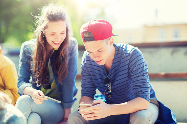 happy teenage friends with smartphones outdoors - Φωτογραφία, εικόνα