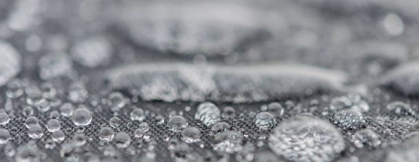 Closeup detailed view of raindrops on a fabric, a background. - Photo, Image