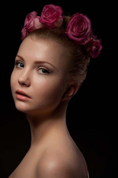 Beautiful young woman beauty shot at dark background - 写真・画像