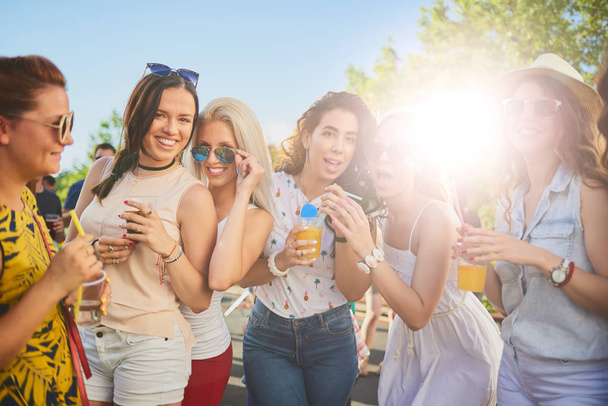 Group of female friends dancing and having a good time at the outdoor party/music festival - Foto, imagen