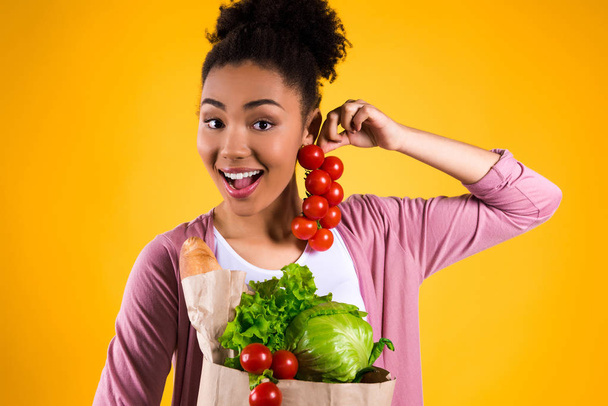 African American girl holding tomatoes isolated. - Фото, зображення