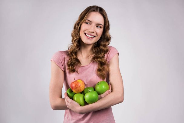 Girl holding green apples, smiling isolated. - Fotoğraf, Görsel