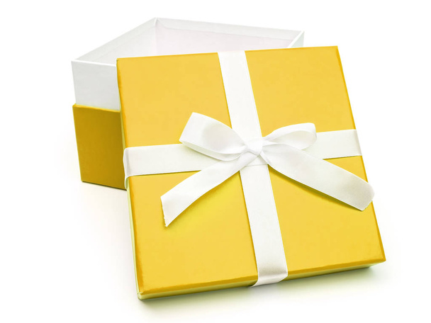 Open yellow box with a gift and white bow - 写真・画像