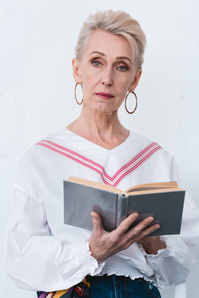 beautiful senior woman reading book, isolated on white - Фото, зображення