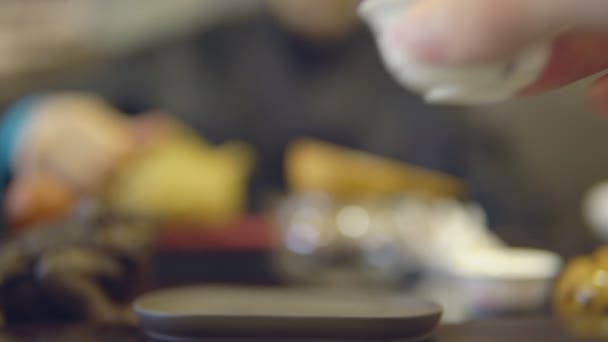 Tea ceremony. Close-up of a white mug on a masters background - Séquence, vidéo