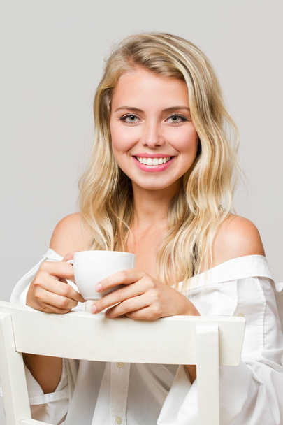 Relaxed blond having coffee. - Foto, afbeelding
